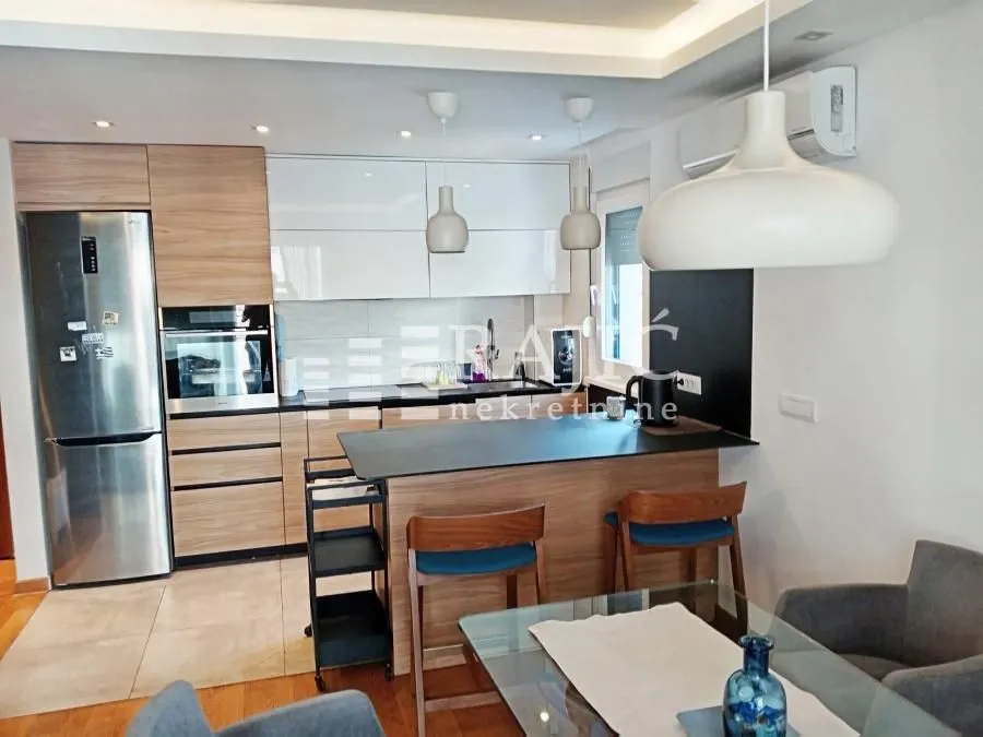 Modern kitchen with a breakfast bar and dining area.