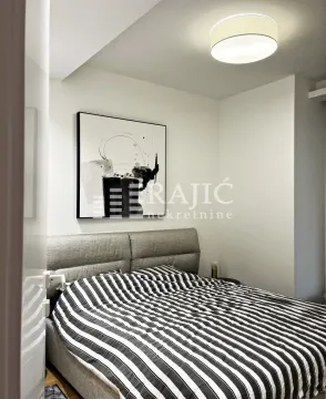 Modern bedroom with a double bed. - image 2