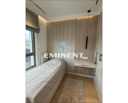 Small bedroom with a bed, built-in wardrobe, and wall panels. - image 8