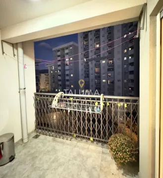 Covered balcony with a metal railing and a view of the buildings. - image 8