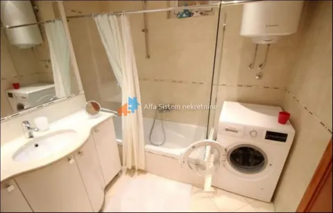 Bathroom with a sink, bathtub, and washing machine. - image 22