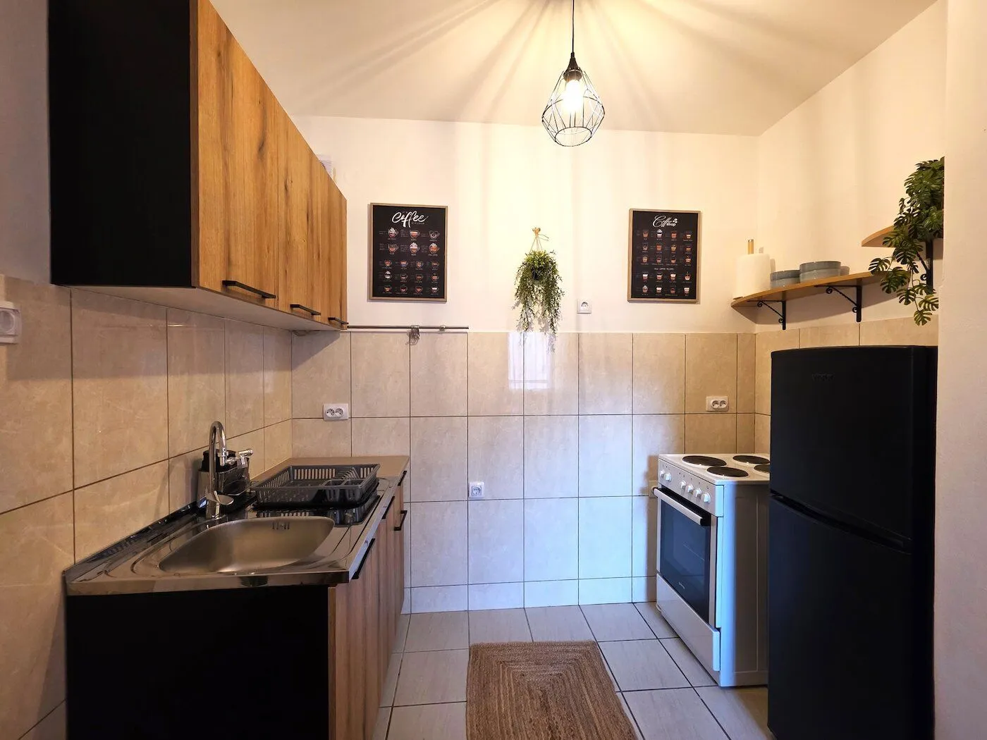 Small equipped kitchen with wooden cabinets and a stove.