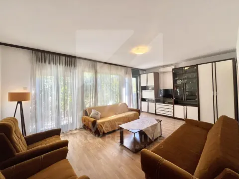 Living room with a sofa set, coffee table, and large windows with curtains. - image 12