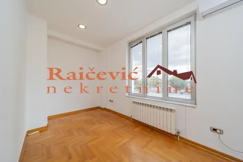Empty room with parquet flooring and a large window. - image 14
