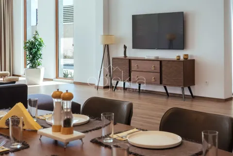 Spacious living room with a dining table and a TV cabinet. - image 10