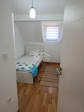 Manja spavaća soba sa krevetom i krovnim prozorom. - image 11