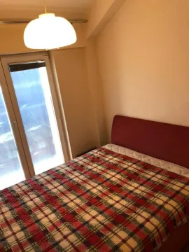 Bedroom with a bed and a window overlooking outside. - image 6