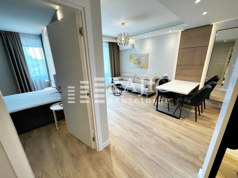 View from the hallway into a bright living room and dining area.