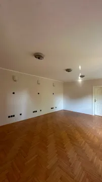 Empty room with wooden parquet flooring and white walls. - image 13
