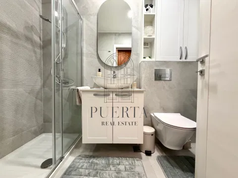 Modernly decorated bathroom with a walk-in shower, washbasin, and wall-mounted toilet. - image 11