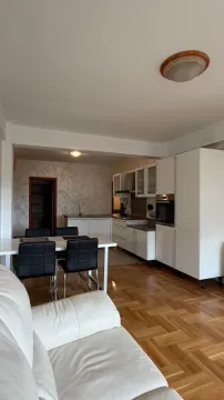 Living room with a dining area and an integrated kitchen in the background. - image 8