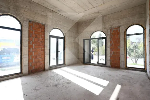 Unfinished room in grey phase with large arched windows. - image 4