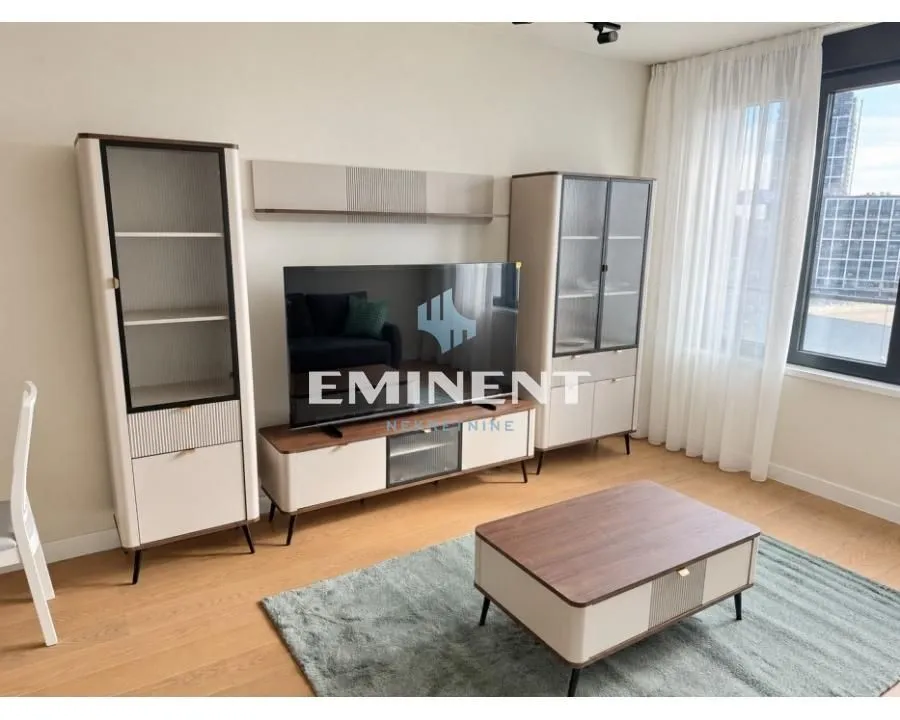 Living room with a TV unit and a wooden coffee table.