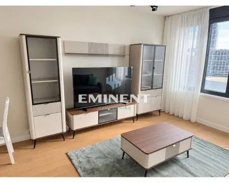 Living room with a TV unit and a wooden coffee table. - image 8