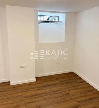 Empty room with white walls and wooden flooring. - image 7
