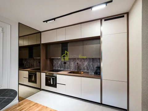 Modern kitchen with built-in units and a coffee machine. - image 9