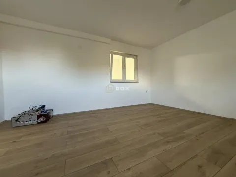Empty room with white walls and wooden flooring. - image 9