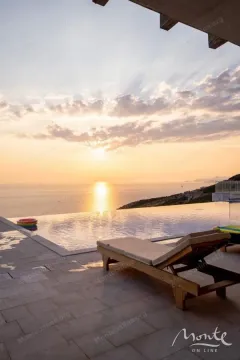 Terrace with a swimming pool and sea view at sunset. - image 26