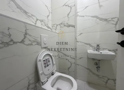 Small bathroom with marble tiles, toilet and washbasin. - image 11