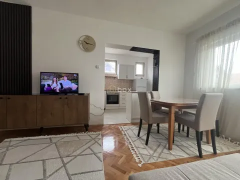 Living room with a dining area and a view of the kitchen. - image 3