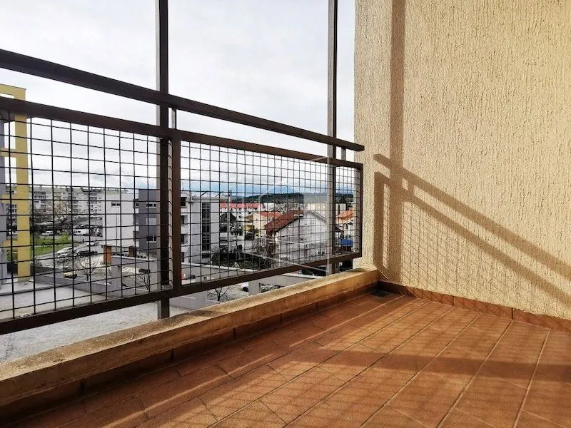 Unfurnished balcony with tiled floor and metal railing.