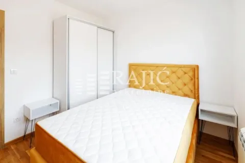 Bedroom with a double bed, white wardrobe, and bedside tables. - image 9