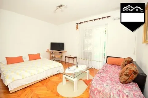 Furnished bedroom with a bed and a TV. - image 11