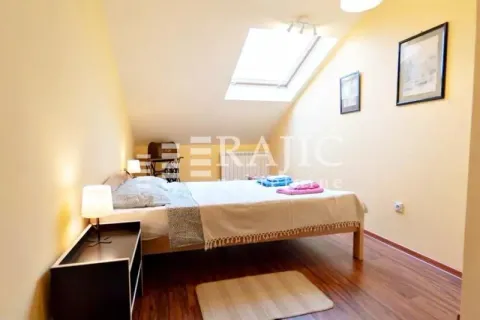 Attic bedroom with a double bed and a roof window. - image 12