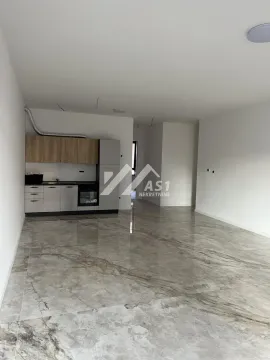Small kitchen in an open-plan space with glossy floor tiles. - image 3