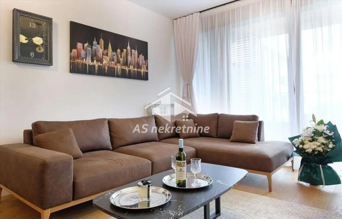 Living room with a corner sofa, coffee table, and large window.