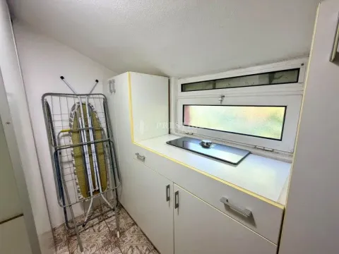 Small kitchen with a built-in hob and cabinets. - image 16