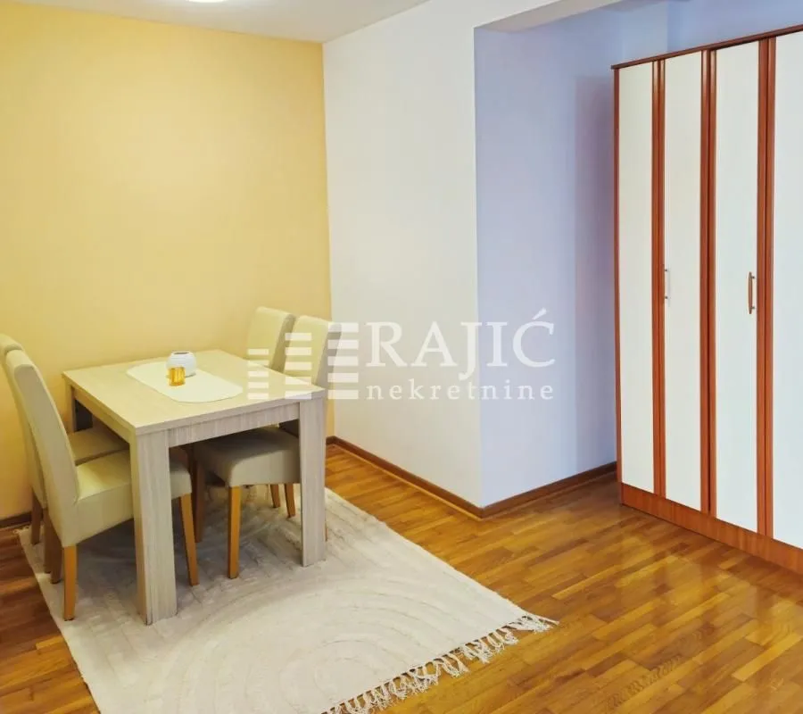 Living room with a dining table and wardrobe.