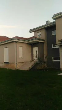Exterior view of a modern house with a green lawn. - image 4