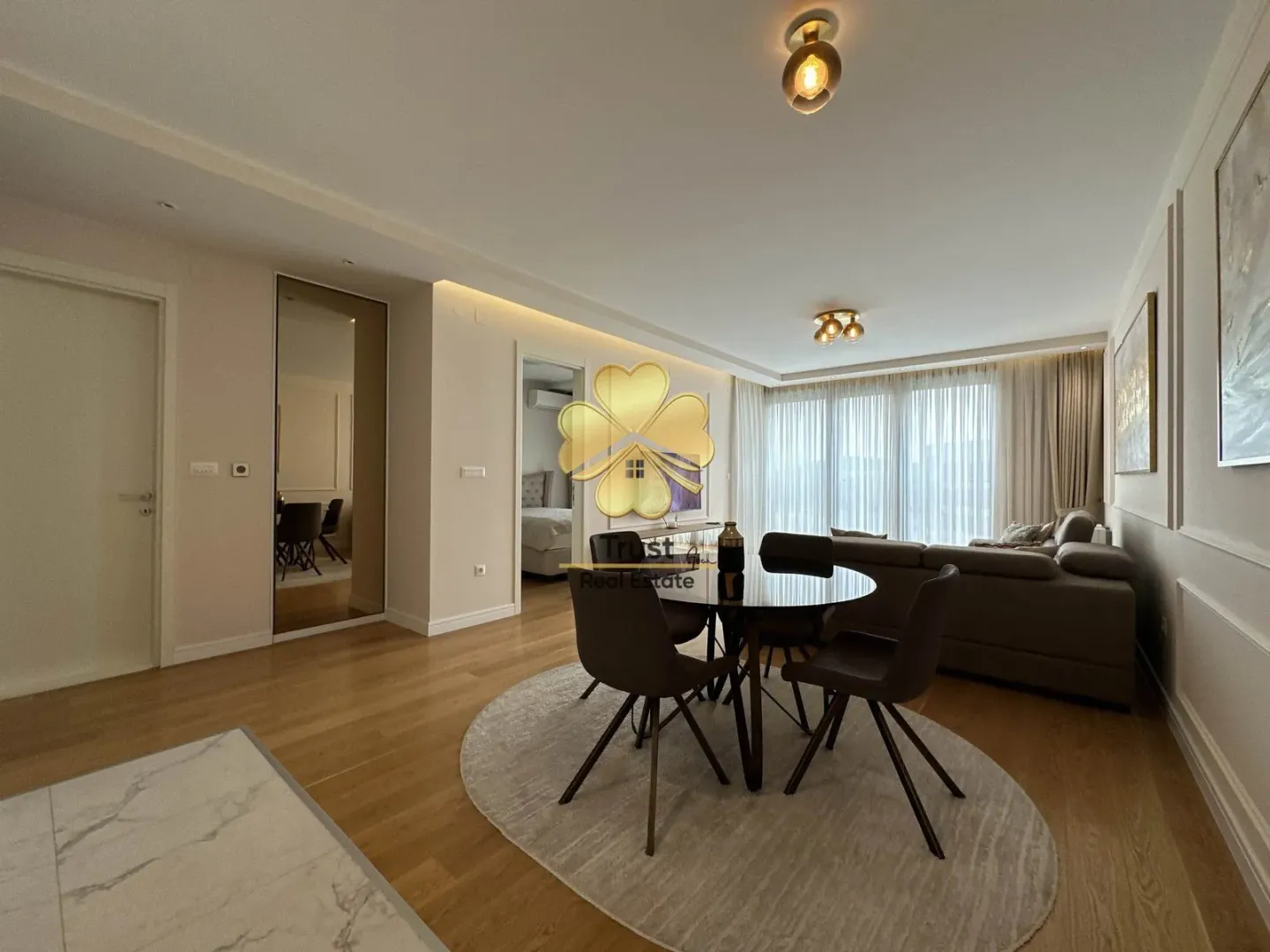 Modern living room with a dining area and seating set.