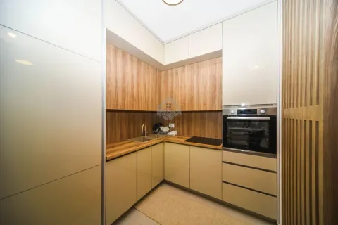 Modern corner kitchen with wooden elements and a built-in oven. - image 6