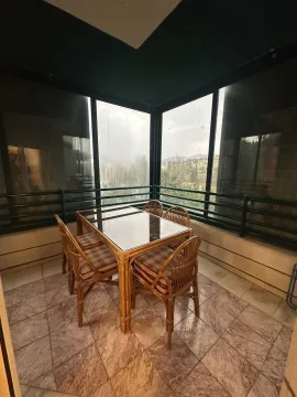 Enclosed terrace with a dining table and chairs. - image 6