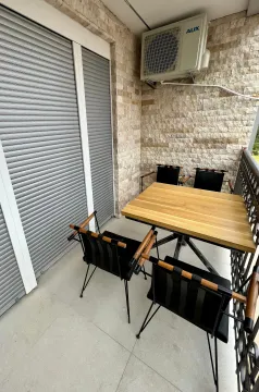 Furnished balcony with a dining table and chairs. - image 4