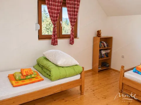 Bedroom with wooden beds and a window view. - image 8