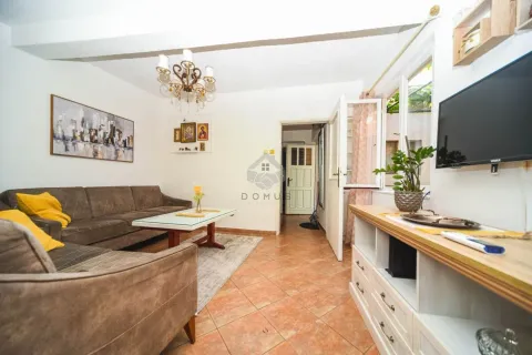 Living room with sofa, coffee table and television. - image 3