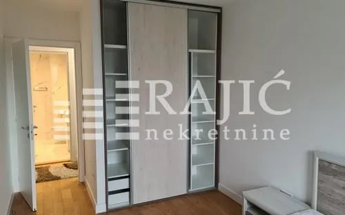 Bedroom with a large built-in wardrobe and a view of the bathroom.