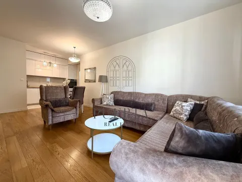 Spacious living room with a sofa set and a dining area in the background. - image 2
