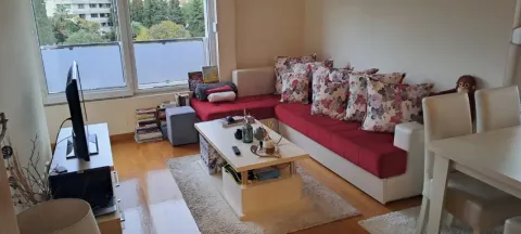 Living room with a corner sofa, coffee table and TV. - image 2