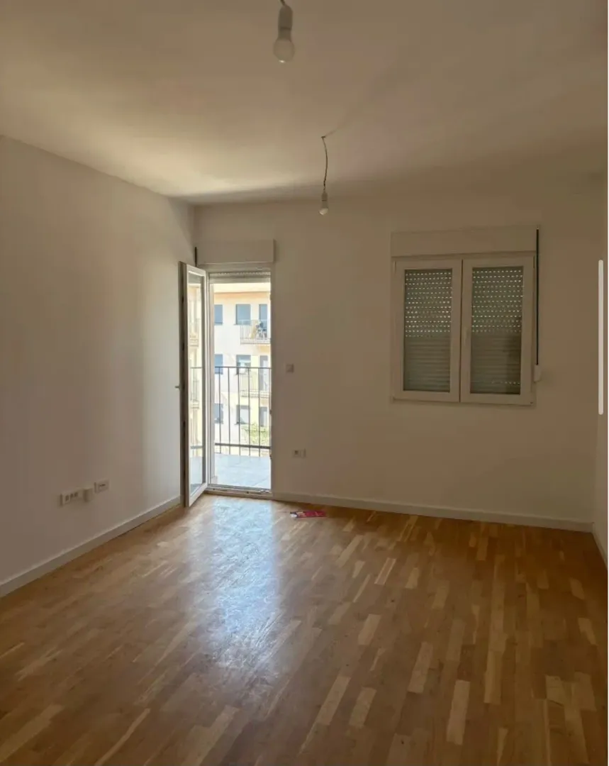 Empty room with hardwood floors and access to a terrace.