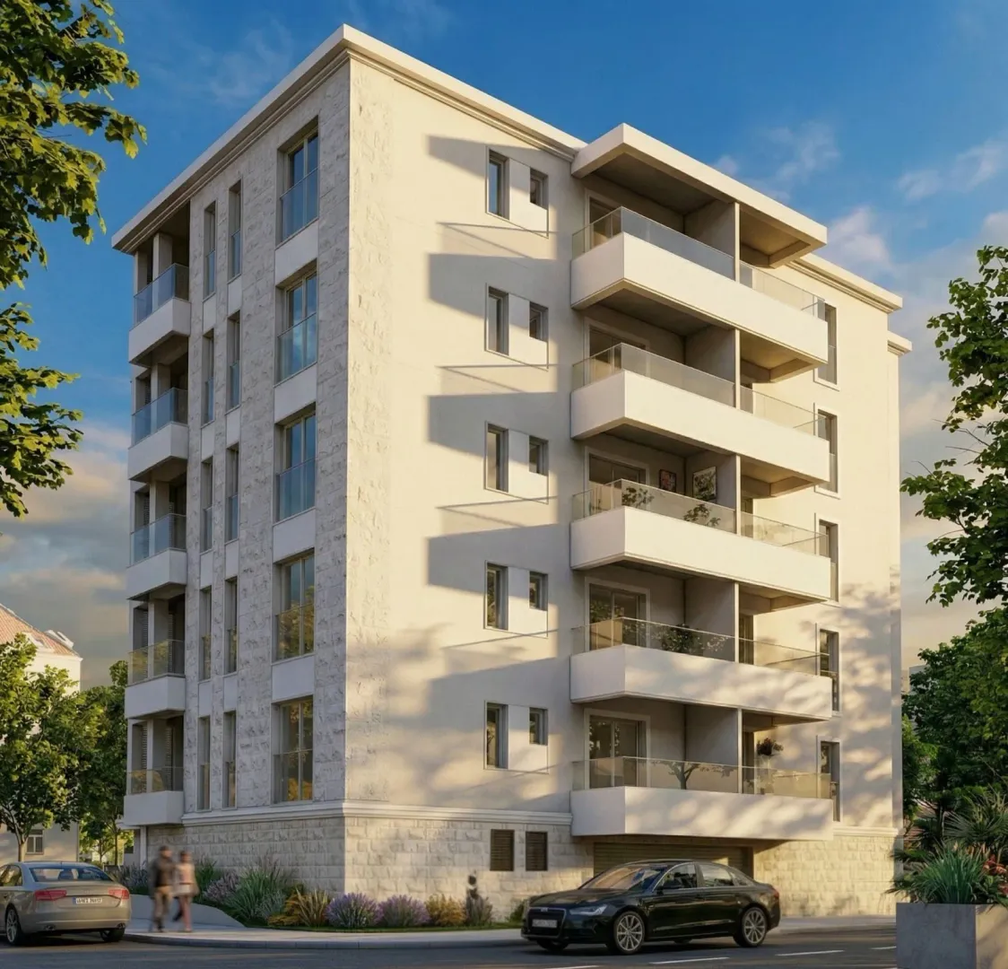 View of a modern residential building with balconies and a landscaped ground floor.