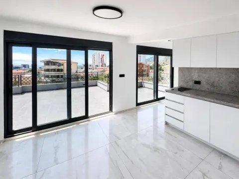 Modern kitchen with white cabinets and access to a spacious terrace. - image 10