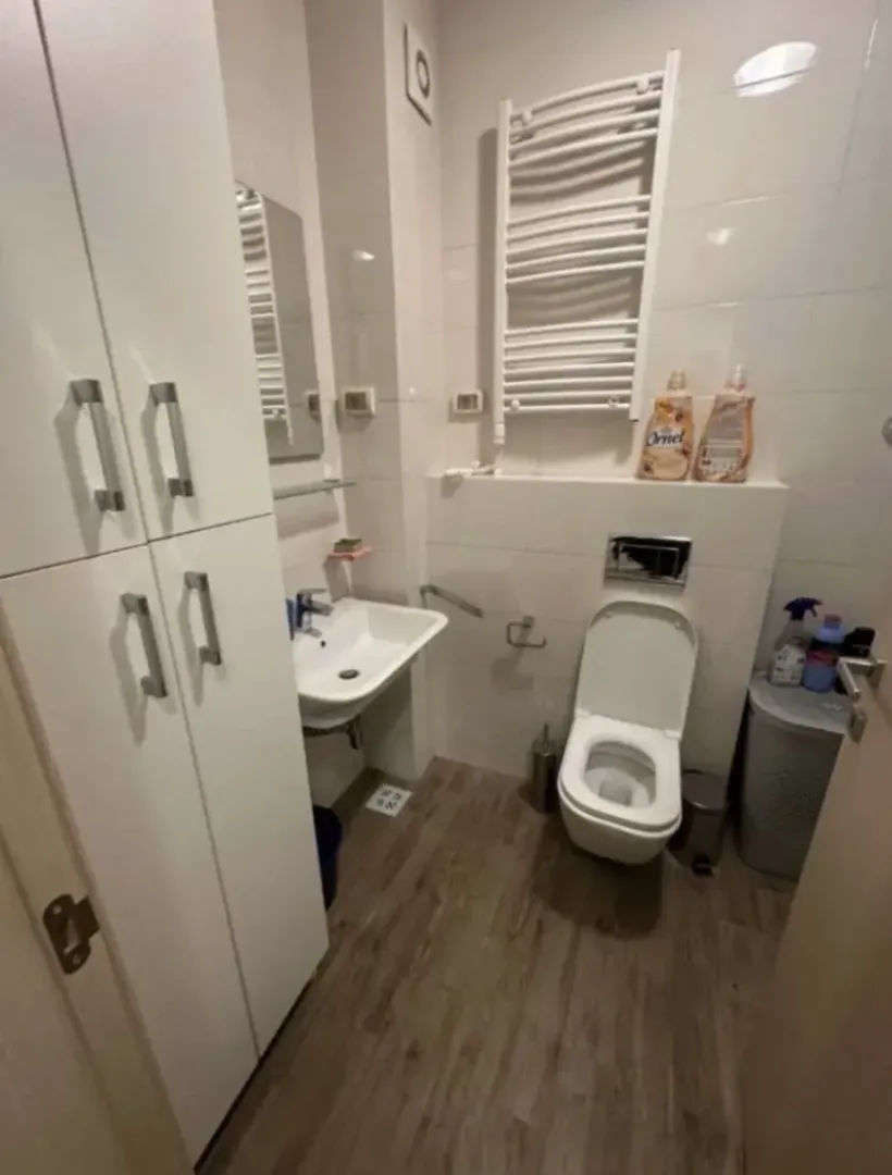 Small bathroom with white sanitary ware and built-in cabinet.