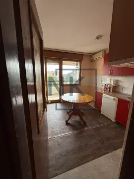 Kitchen with a dining table and access to the terrace. - image 5