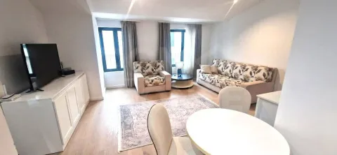 Living room with a sofa set, TV, and dining table. - image 5