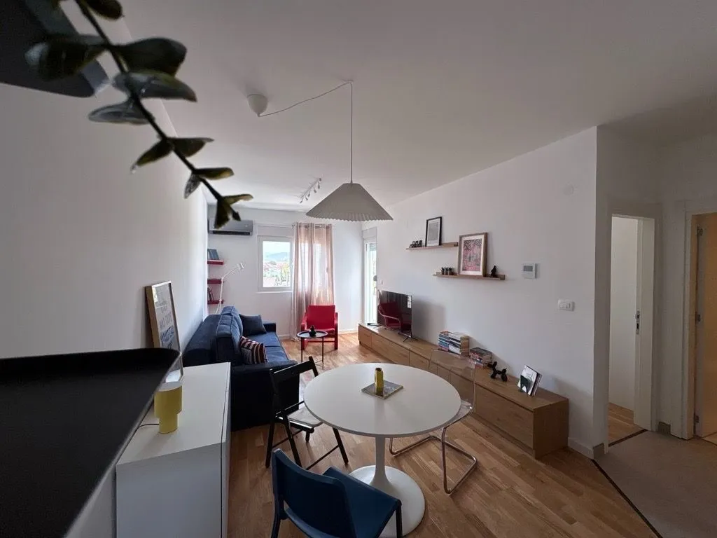 Living room with dining area and seating furniture.