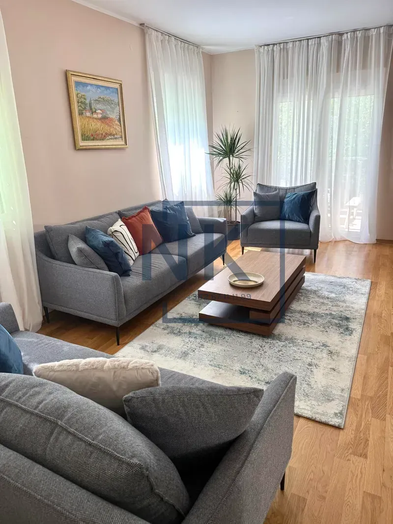 Comfortable living room with gray sofas and a wooden coffee table.